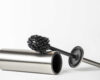 Black toilet brush isolated on white. Close-up of a toilet cleaning brush with metal elements to insert into a project or design. Metal brush for the toilet on a white background.