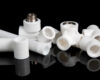 plumbing fittings for plastic pvc pipes on black background